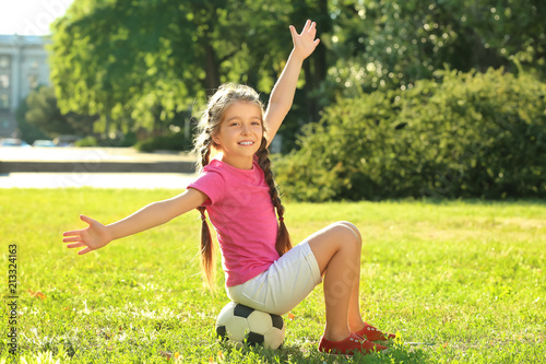 Cute girl sitting on soccer...
