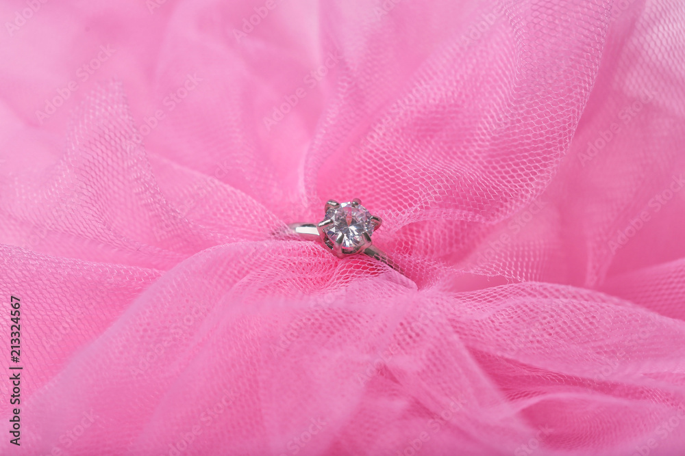 Beautiful engagement ring on pink tulle, closeup Beautiful engagement ring on pink tulle, closeup
