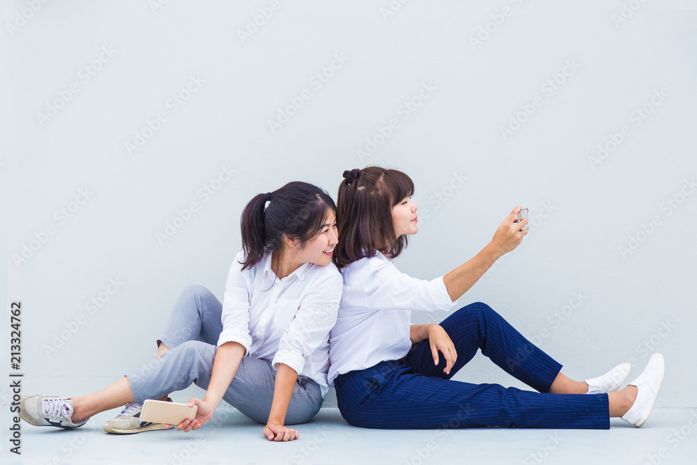 Young Asian women enjoy taking their selfies to share on social media with room for copyspace