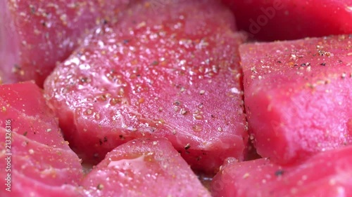 Fresh and uncooked tuna with dressing rotate