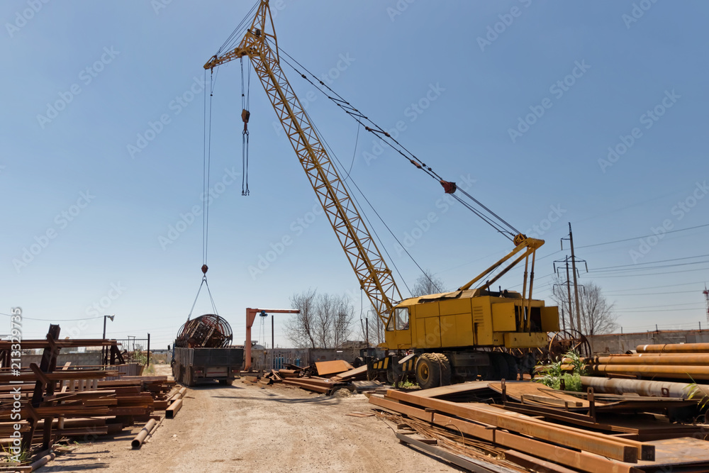 Loading of large metal structures on the truck with a crane