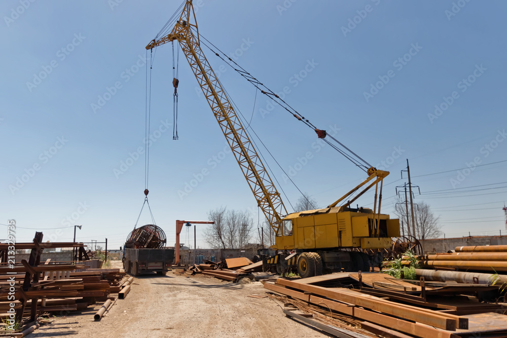 Loading of large metal structures on the truck with a crane Loading of large metal structures on the truck with a crane
