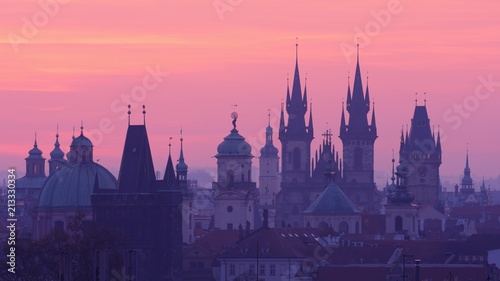 Sunrise behind the Prague Panorama of the Old Town Towers