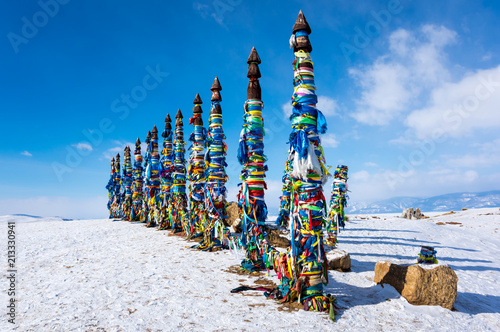 Wooden ritual pillars with colorful ribbons on cape Burkhan