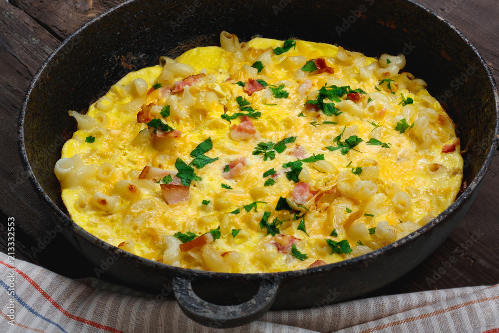 Traditional rustic omelette with bacon, pasta and greens Traditional rustic omelette with bacon, pasta and greens