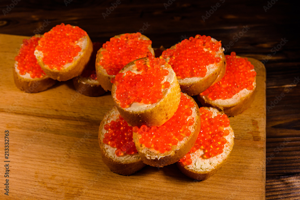 Sandwiches with red caviar on a cutting board Sandwiches with red caviar on a cutting board