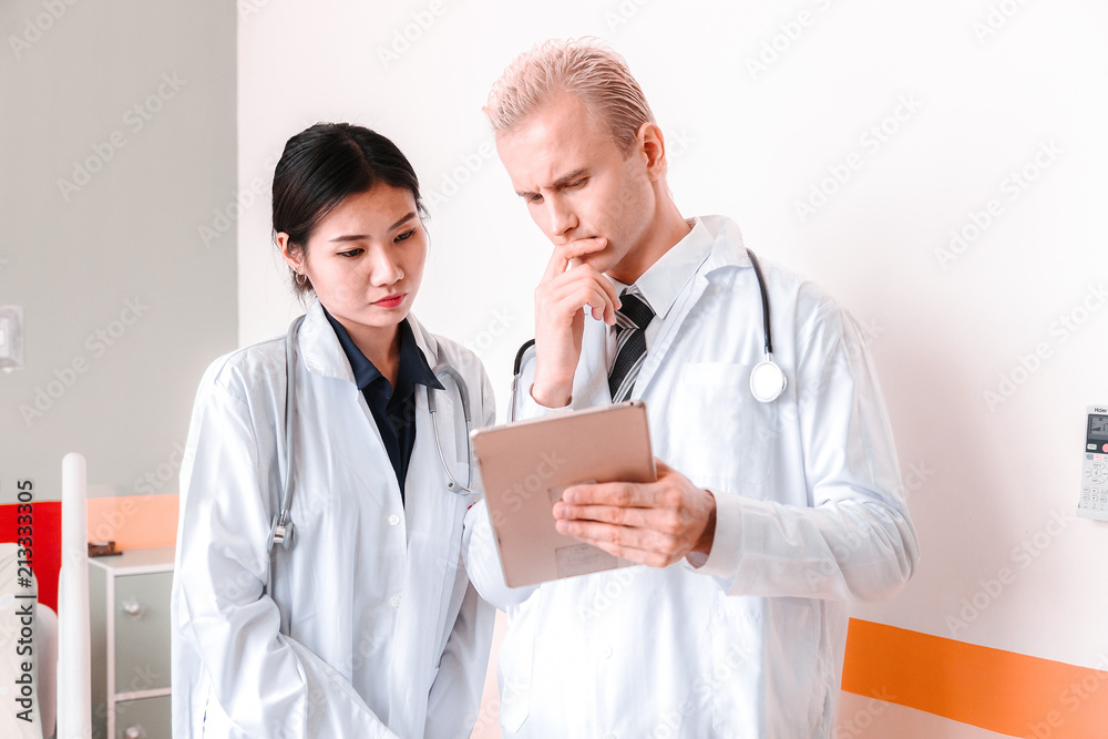 Medical team at the hospital checking paperwork and patient's medical records, healthcare and teamwork concept. Medical team at the hospital checking paperwork and patient's medical records, healthcare and teamwork concept.