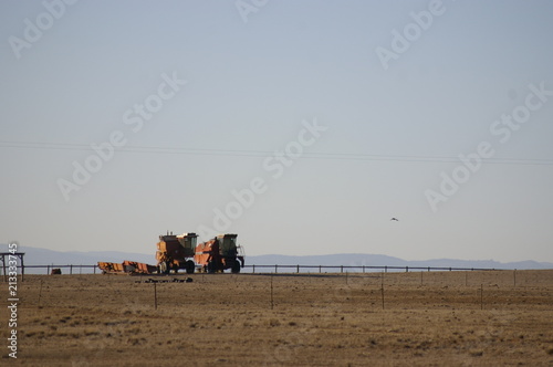 Old unworking red harvesting machinery on a dry drought stricken farm in Rural New South Wales on a hot dry day photo