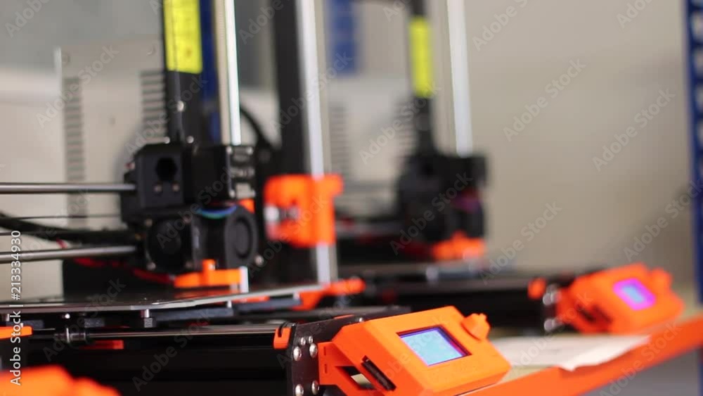 Close up of three brand new Prusa MK 3 3D printers, printing.