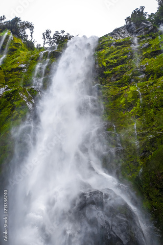 Waterfall in Milford Sound lake  New Zealand