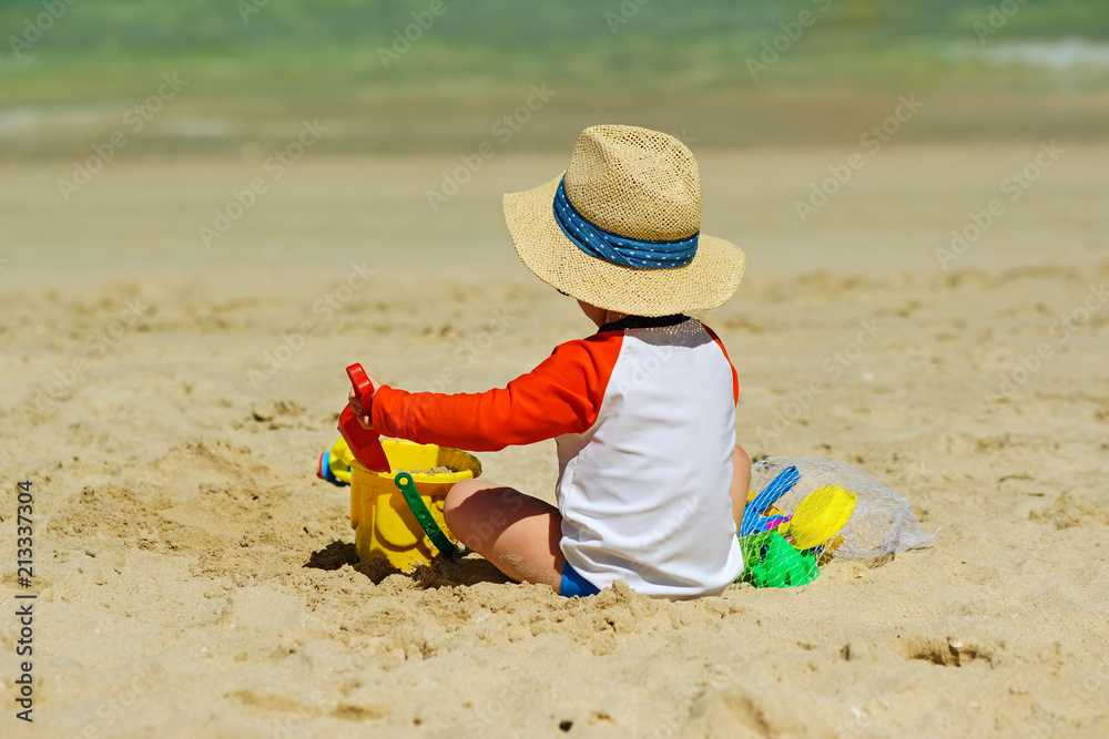 Two year old toddler playing on beach Two year old toddler playing on beach