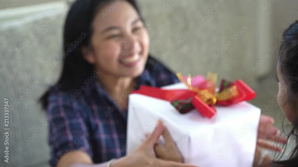 Daughter give mom the surprise gift ,Concept of Mother day in slow motion footage Daughter give mom the surprise gift ,Concept of Mother day in slow motion footage