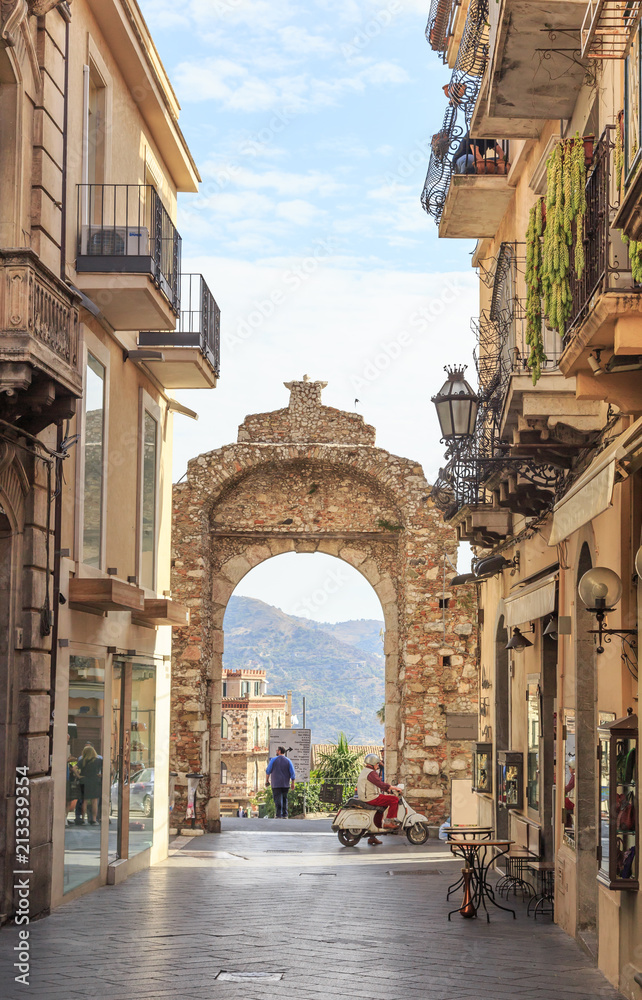 Messina Gate (Porta Messina) in Taormina. It is north entrance of  historical center of town which leads to  main street of Taormina - obrazy, fototapety, plakaty 