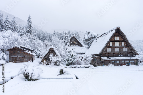 ancient houses and white snow is heavy and covered throughout Shirakawa-go village in Gifu, Japan.