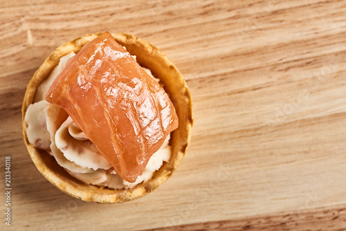 tartlets with mascarpone and red fish on a wooden table. copyspace. photo