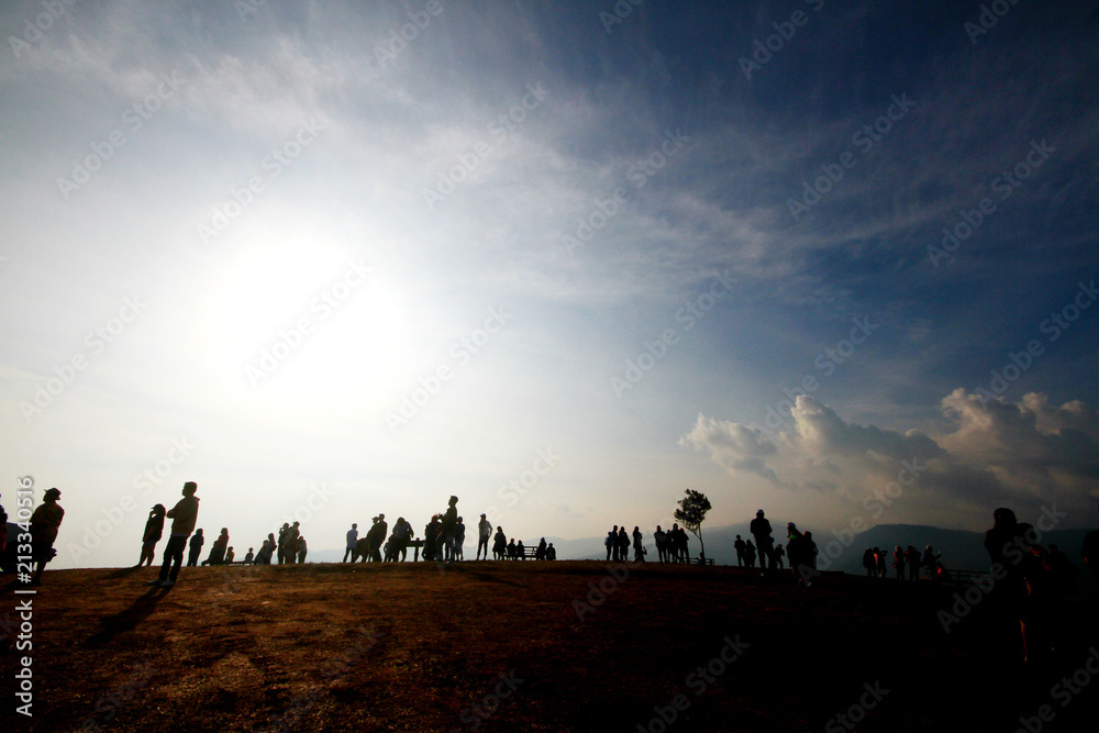 Silhouette of people in beautiful sunrise on the mountain at Thailand. Ultra violet and copy space.