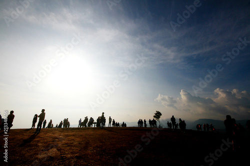 Silhouette of people in beautiful sunrise on the mountain at Thailand. Ultra violet and copy space. © cocorattanakorn