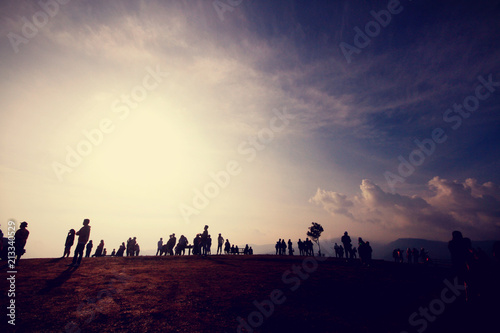 Silhouette of people in beautiful sunrise on the mountain at Thailand. Ultra violet and copy space.
