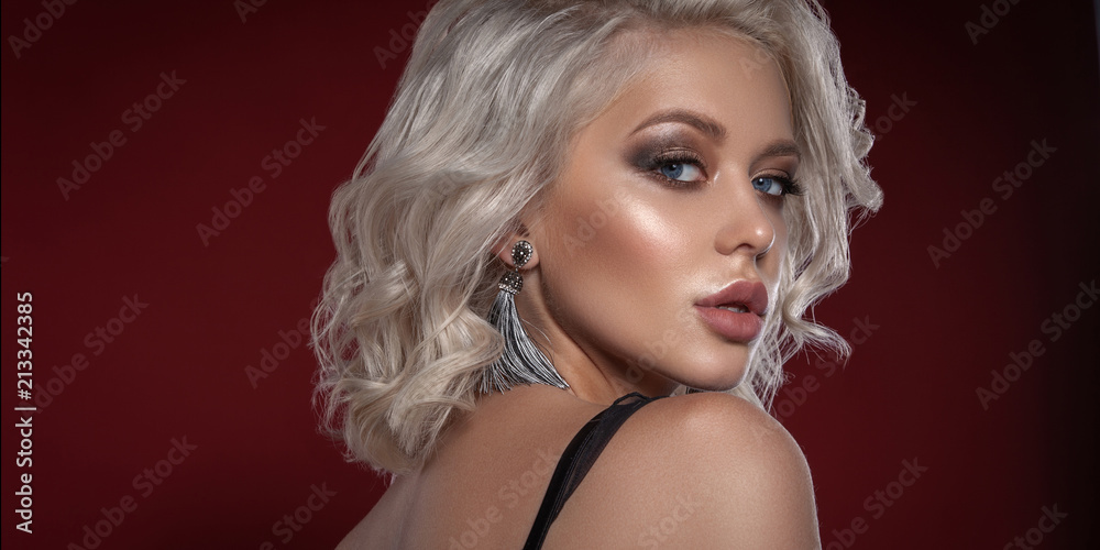 © tatyaby - Glamorous Beauty portrait of a superb blonde girl. Bright makeup, chubby lips. Chic decoration.