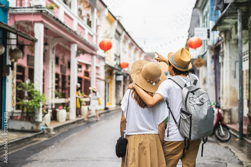 Young couple traveler walking at Phuket old town in Thailand photo