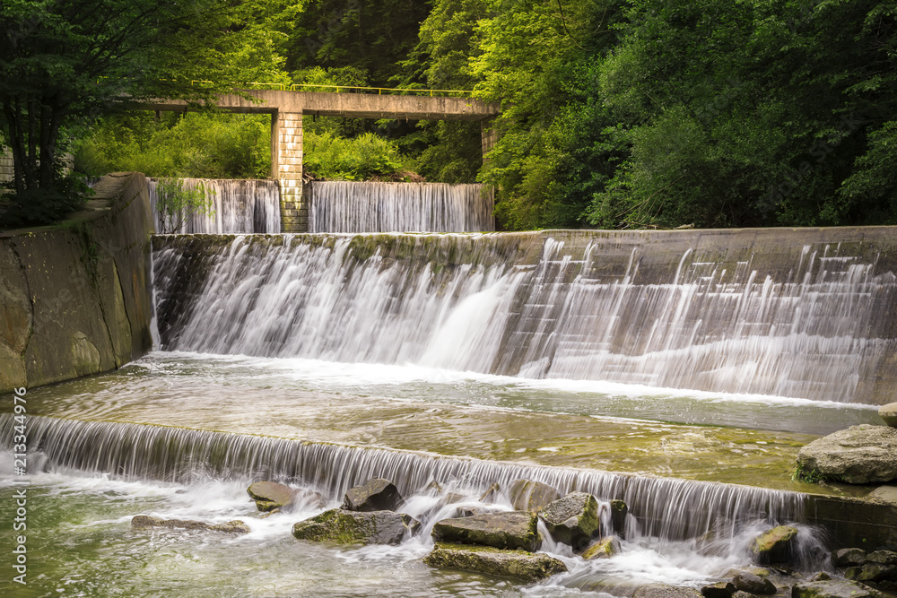 Fototapeta premium Rapid mountain river in a succession of waterfalls