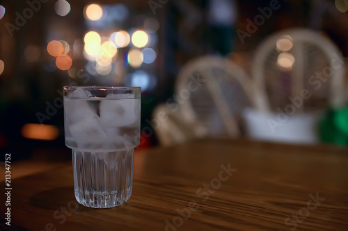 glass of water with ice in the restaurant   cold clear clear water in a glass with ice pieces