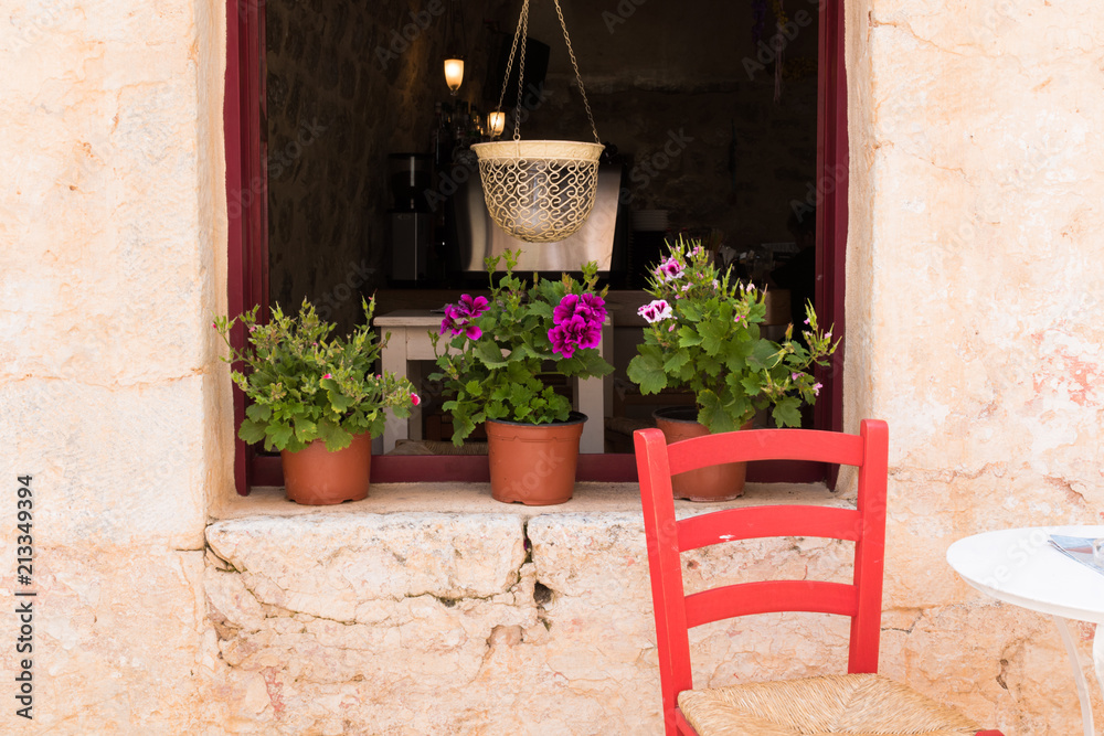 Window with flowers and a chair