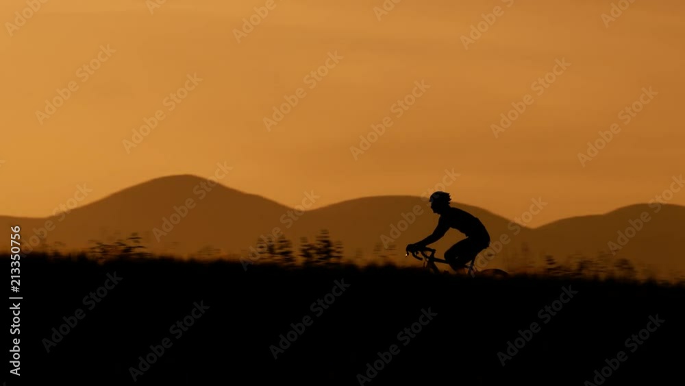 Pan tracking of road cyclist silhouette in the morning Pan tracking of road cyclist silhouette in the morning