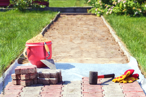 Laying of paving slabs in the garden photo