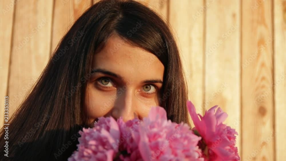 Slow motion of portrait of a young beautiful woman with a bouquet of peonies. Slow motion of portrait of a young beautiful woman with a bouquet of peonies.