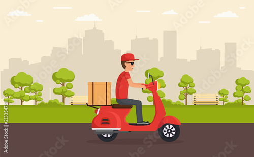 Delivery service on scooter. Boy fast and free delivers food or goods on scooter driving through park on background city.