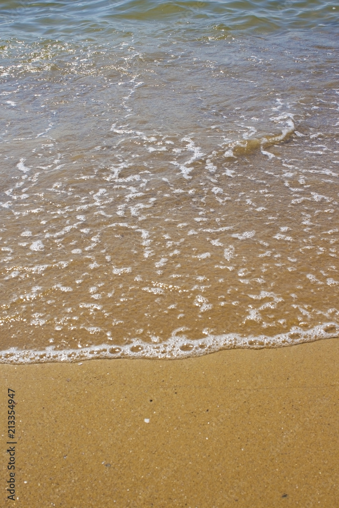 Soft wave of the sea on the sandy beach