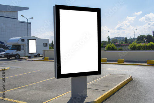 two Blank white mock up of vertical light box billboard at car park