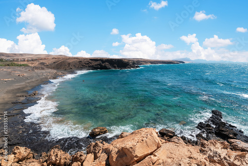 View of the beach from the wall in the municipality of Pájara on the island of Fuerteventura, Canarias, Spain.