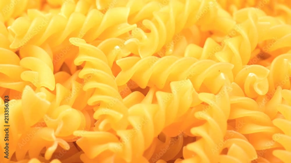 UHD macro of the dry Fusilli pasta on a rotating stand UHD macro of the dry Fusilli pasta on a rotating stand