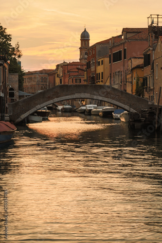 Idyllic sunset over the canal of Venice in Italy