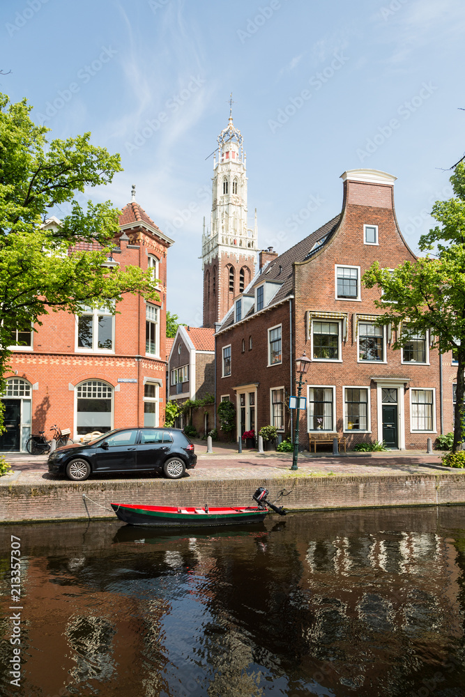 Traditional Dutch houses along a canal on a sunny day in Haarlem in the Netherlands, Europe