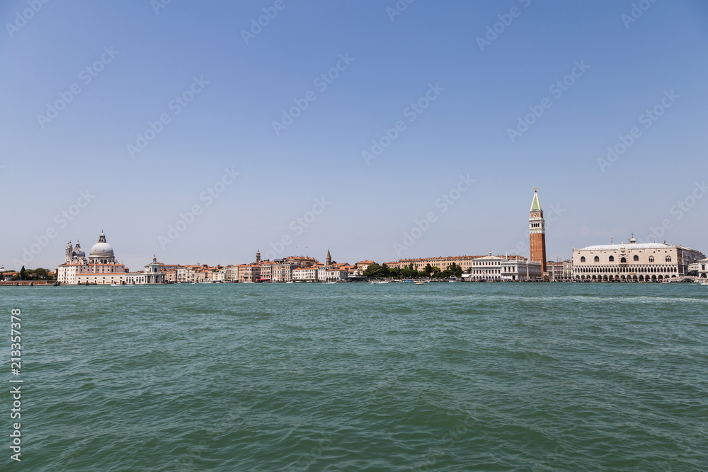 The famous San Marco Campanile and the Doges Palace in front of the Grand Canal and the basilica di santa maria della salute in Venice.