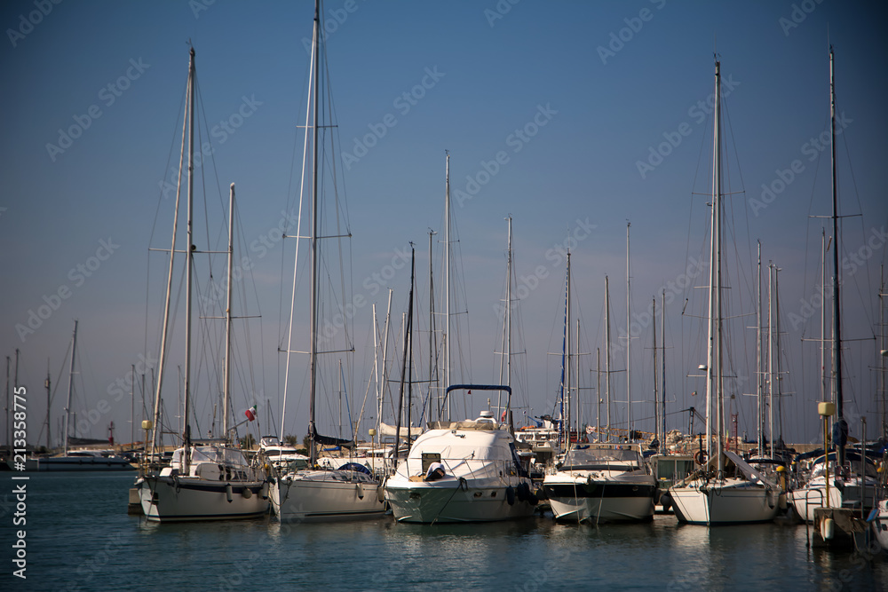 Boats moored in the harbor at sunset Boats moored in the harbor at sunset