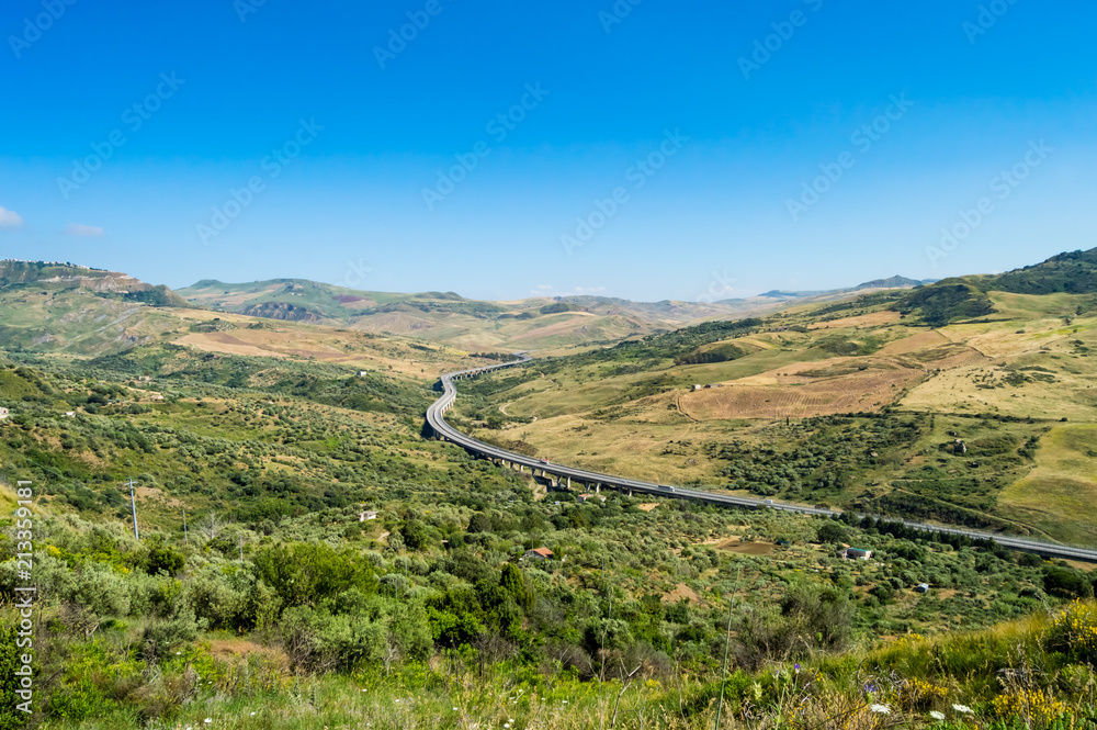 Four-lane highway spiraling through the countryside