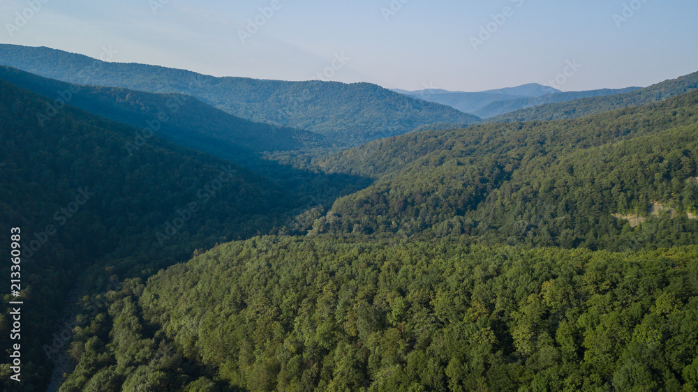 Russian Forest And Mountains Under Blue Sky By Aerial Drone. Stunning Aerial Drone Stock Footage of South russian Forest And Mountains Under Blue Sky