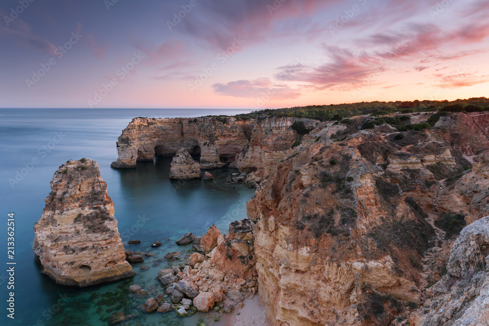 Amazing sunset at Marinha Beach in the Algarve, Portugal. Landscape with strong colors of one of the main holiday destinations in europe. Summer tourist attraction.