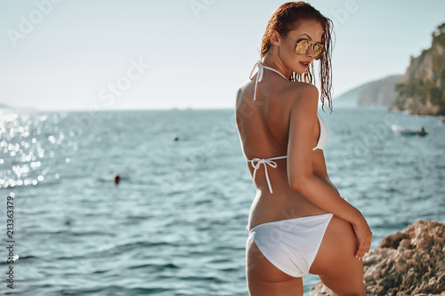 Pretty slim girl at sea beach