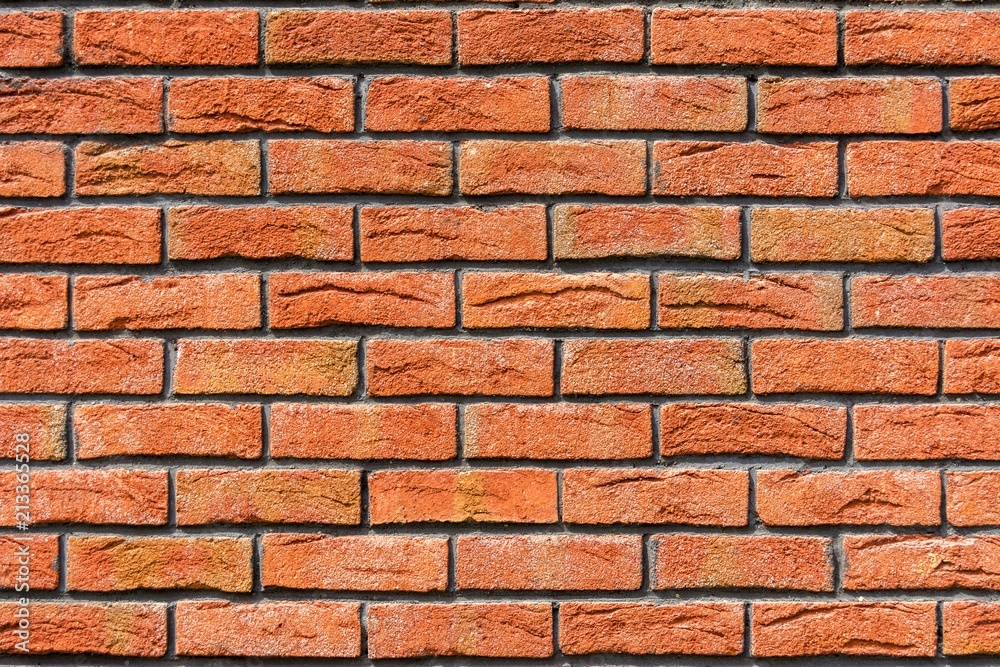 Red brick wall. Decorative brick with artificial defects and cracks. Red brick wall. Decorative brick with artificial defects and cracks.