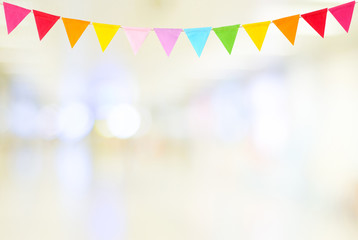 Colorful party flags hanging on blur abstract background, birthday, anniversary, celebrate event, festival greeting card background