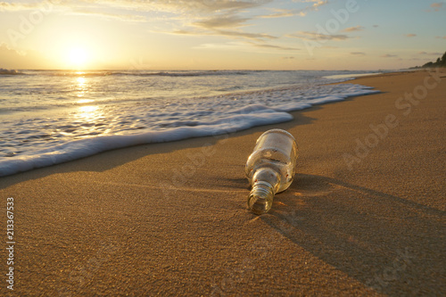 Glass bottle with beatiful beach sunset landscape