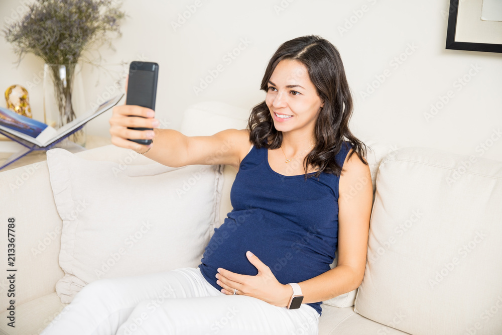 Pregnant Woman Taking Selfie On Smartphone At Home Pregnant Woman Taking Selfie On Smartphone At Home