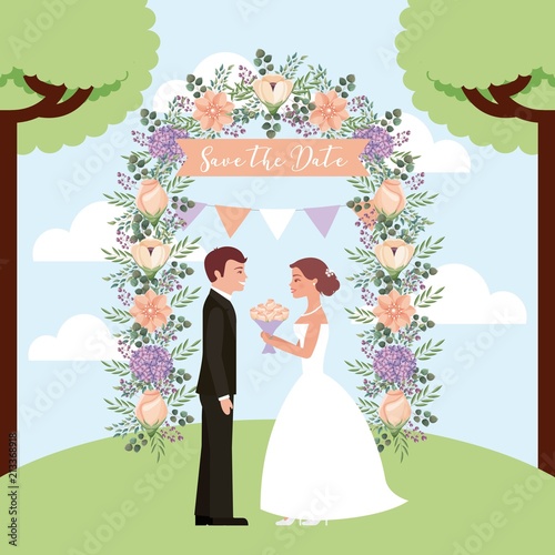 bride with bouquet and groom in arch flowers save the date card
