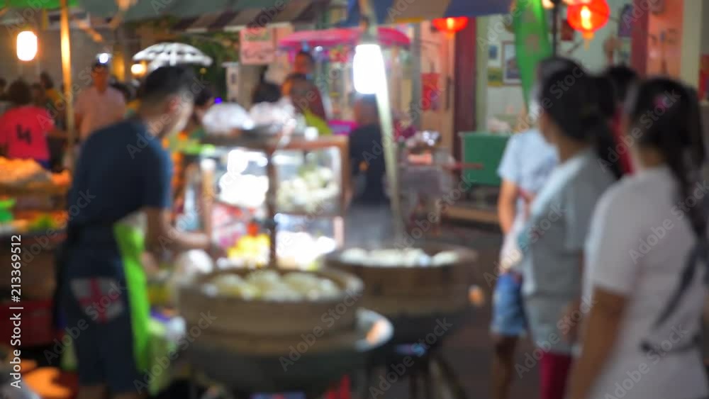 4K Timelapse Movie Thai Local Vendors Selling Food and Clothes at Famous Sunday Night Market in Songkhla Old Town. Tourists Walking and Shopping. Songkhla, Thailand - 14/07/2018.