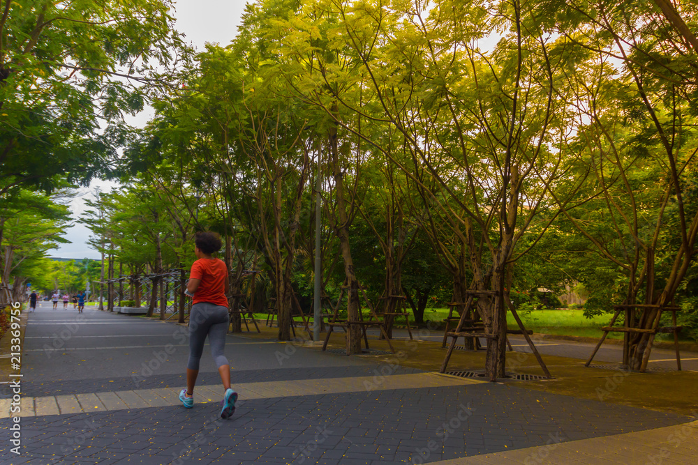 young fitness sports woman runner running on tropical park
